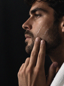 Barber applying PION Ice Feel Face Tonic after a shave.